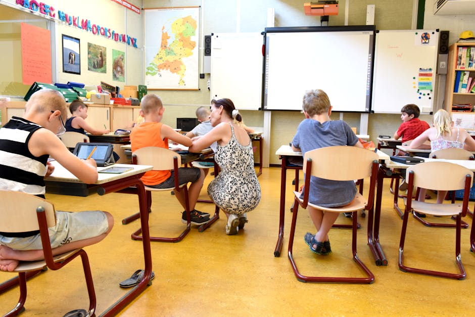 Children engaged in learning with a teacher in a bright classroom setting